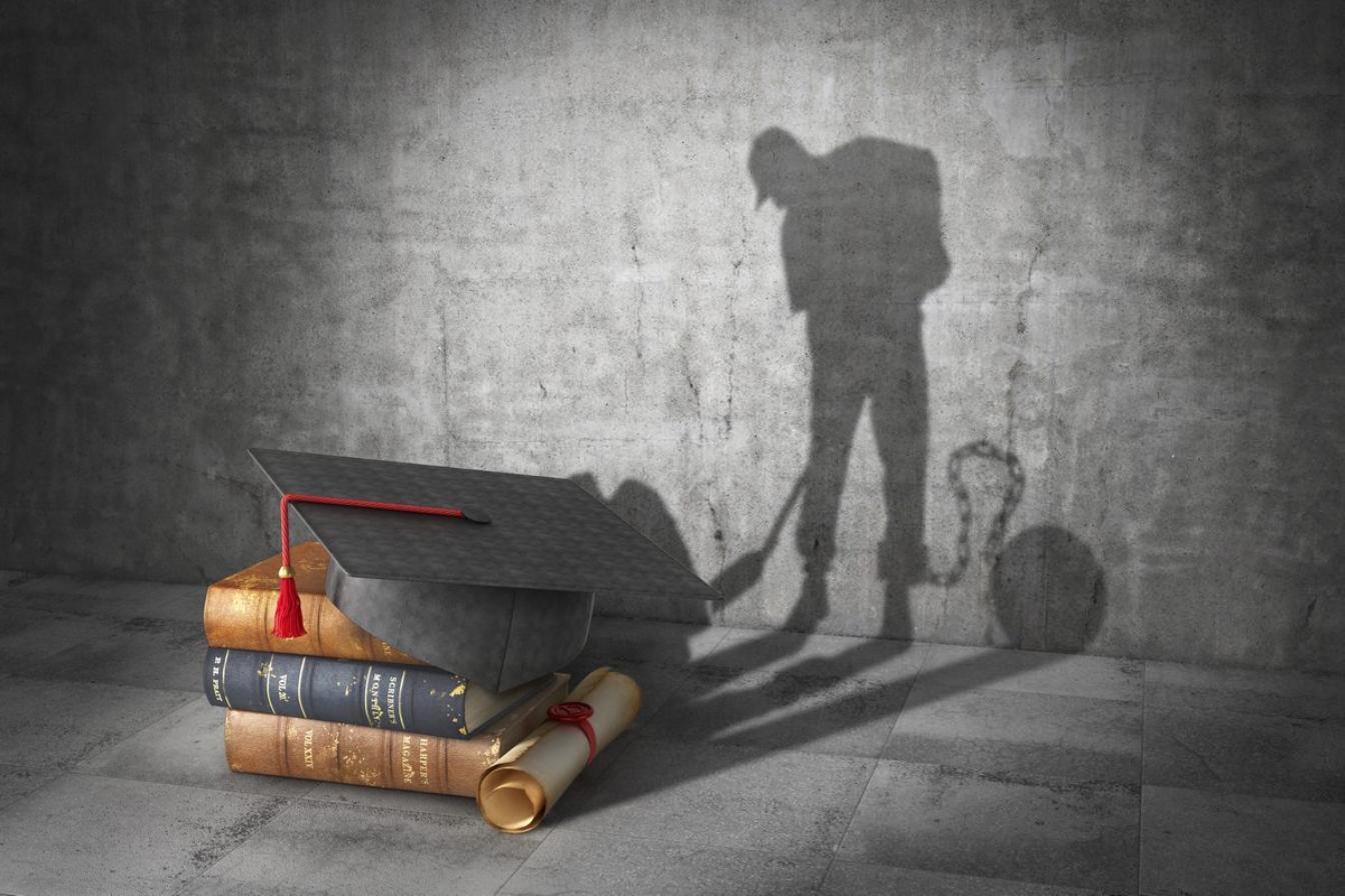 Education concept. Learning to be a slave. Book with diploma cas